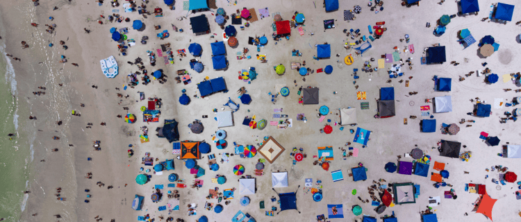 Aerial view of UK beach with sun umbrellas up: Pension Lifestyling What You Need to Know